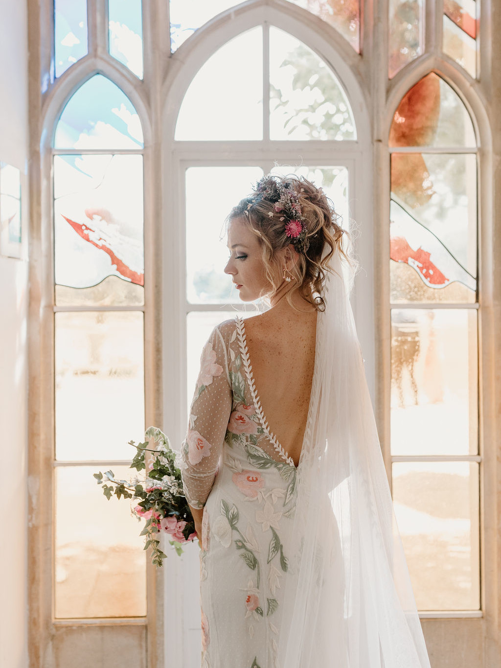 Bride in front of stained glass windows